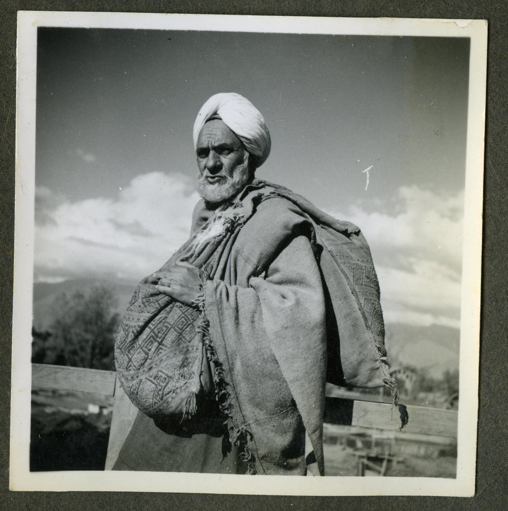 "Kashmir Types," an older man carrying sacks
