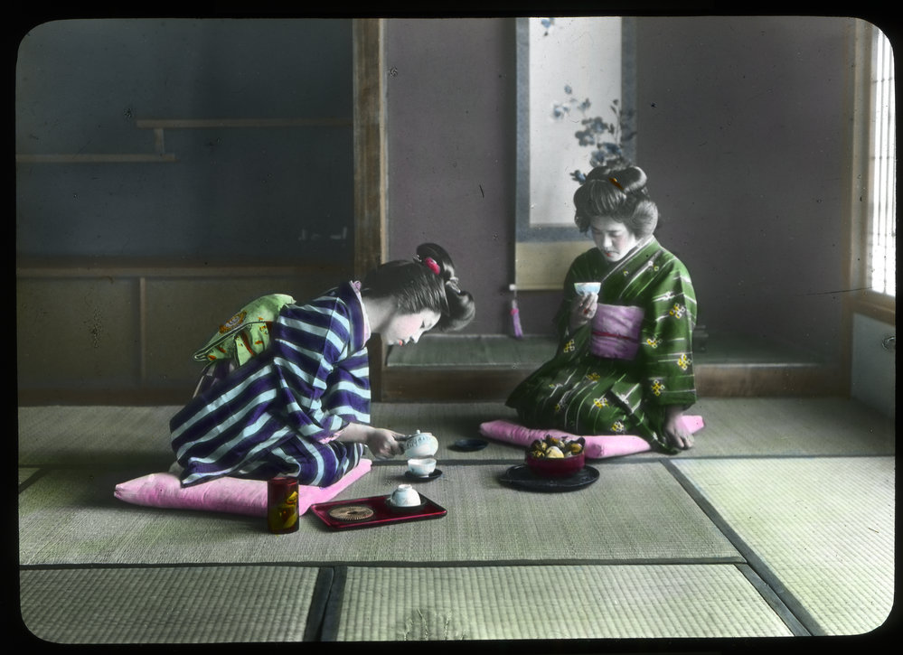 "A woman making tea for her visitor"