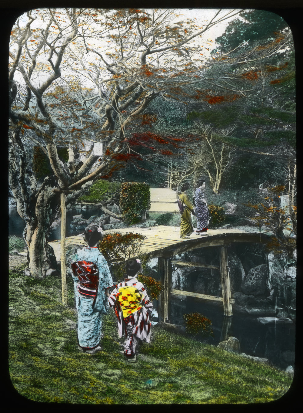 "Geisha girls upon a bridge over the pond in a tea house garden"