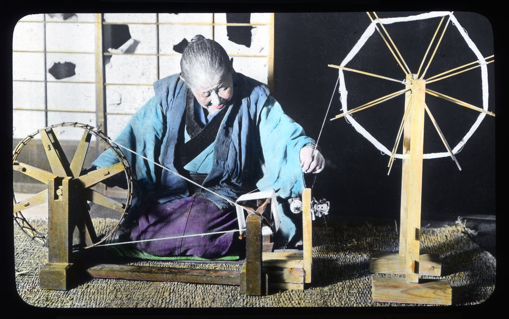 "A hand spinning wheel used by an old woman for winding a spool"