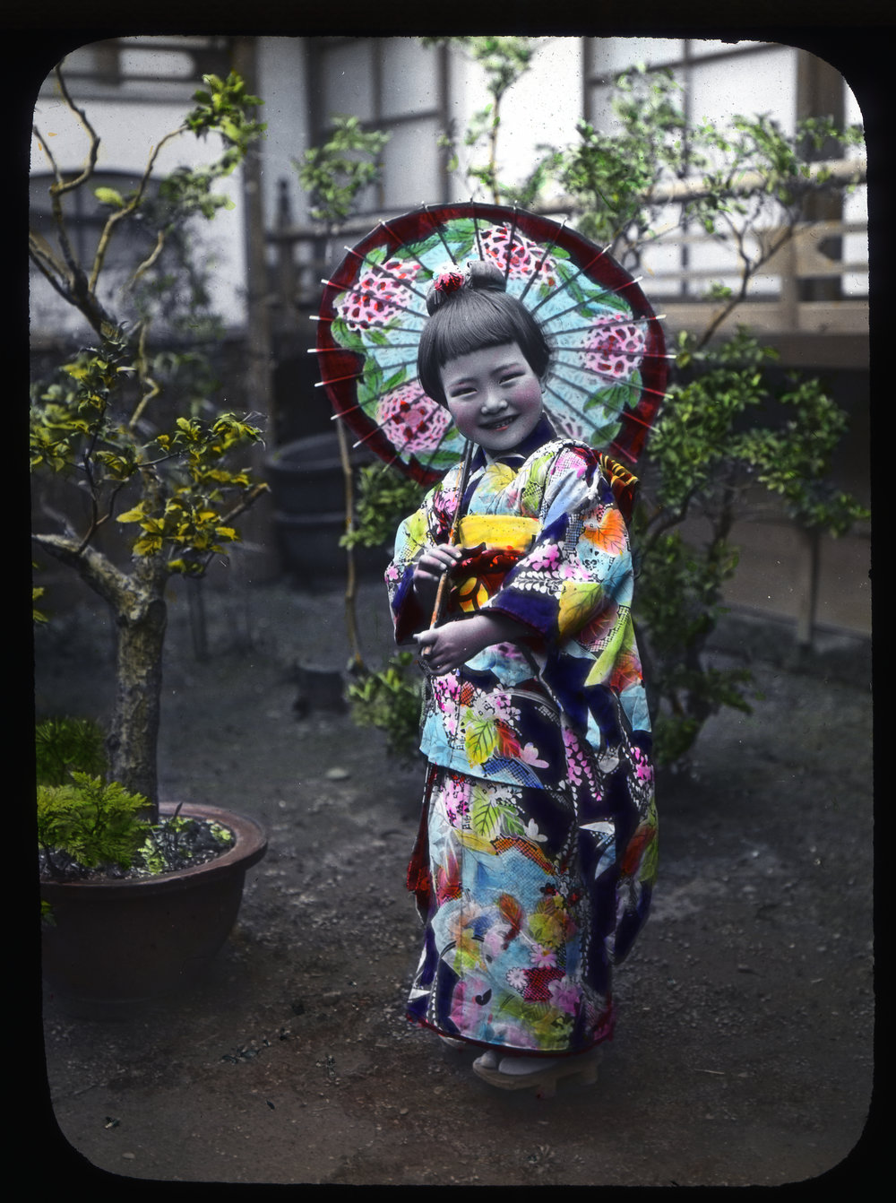 "A girl standing in the yard with a sunshade" 