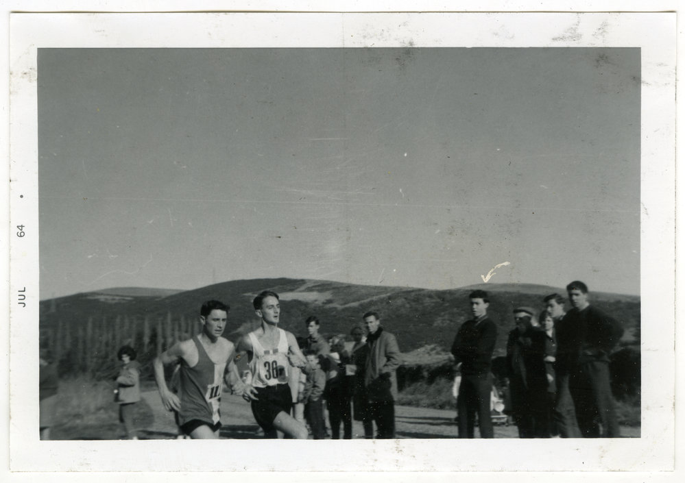 "Graeme Martin (first non-team man home), battles with Ian Priest (Hutt)," St. Andrew's Trophy, Christchurch, 1964, Presbyterian Harrier Club - Wellington