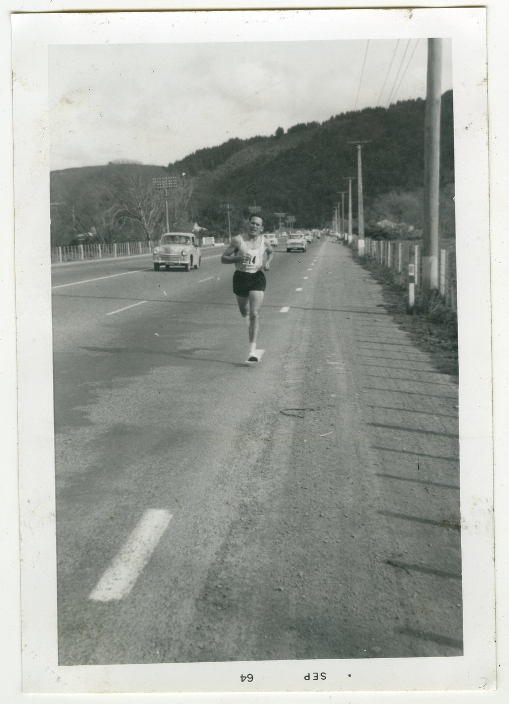 "Norm Gosling sticking to the white line - Taita to Upper Hutt," Masterton Relay, 1964, Presbyterian Harrier Club - Wellington