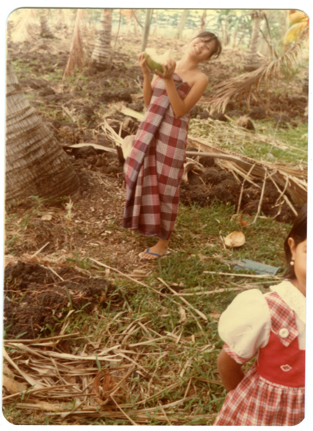 Evelyn Kapa Carrying a Young Coconut