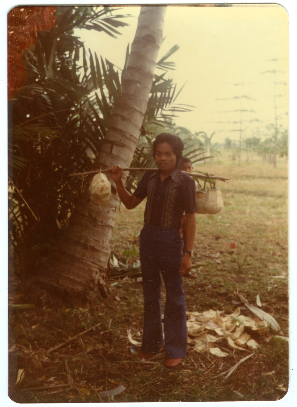 Johanes Carrying Coconuts