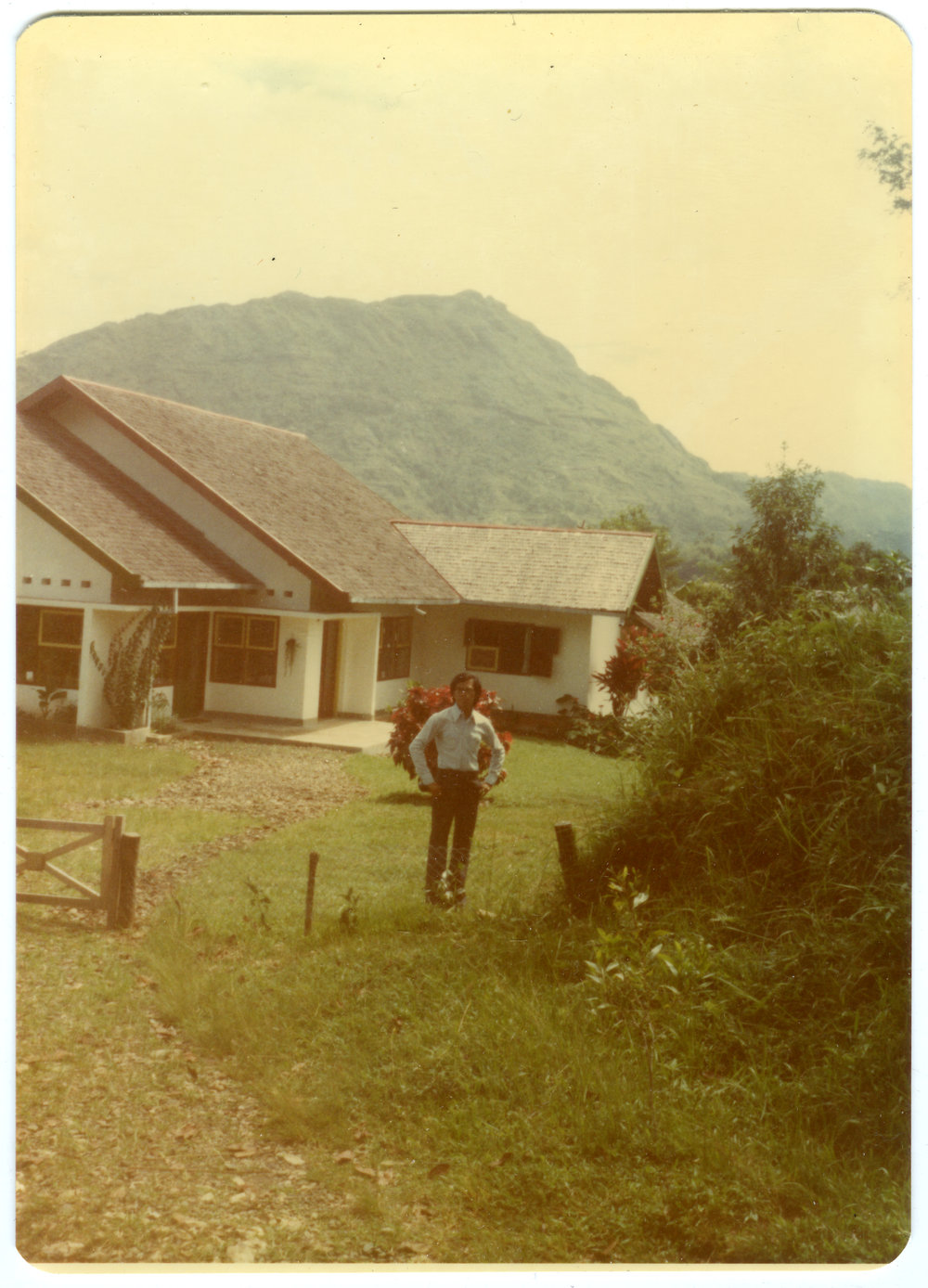 Johanes Rante Banu in Front of One of the Houses at Tangmentoe