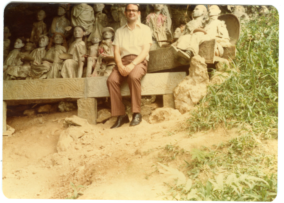 Robert Patterson in Front of the Statues of the Deceased at Kete