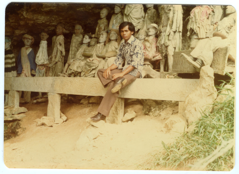 Andarias Lebang in Front of the Statues of Deceased at Kete