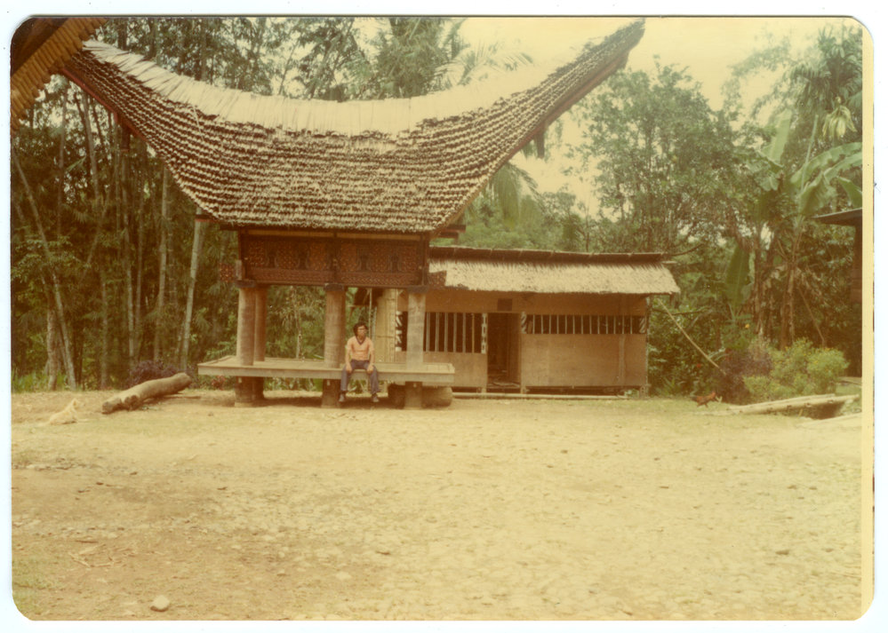 Johanes Rante Banu Sitting under a Rice Storehouse "lumbung"