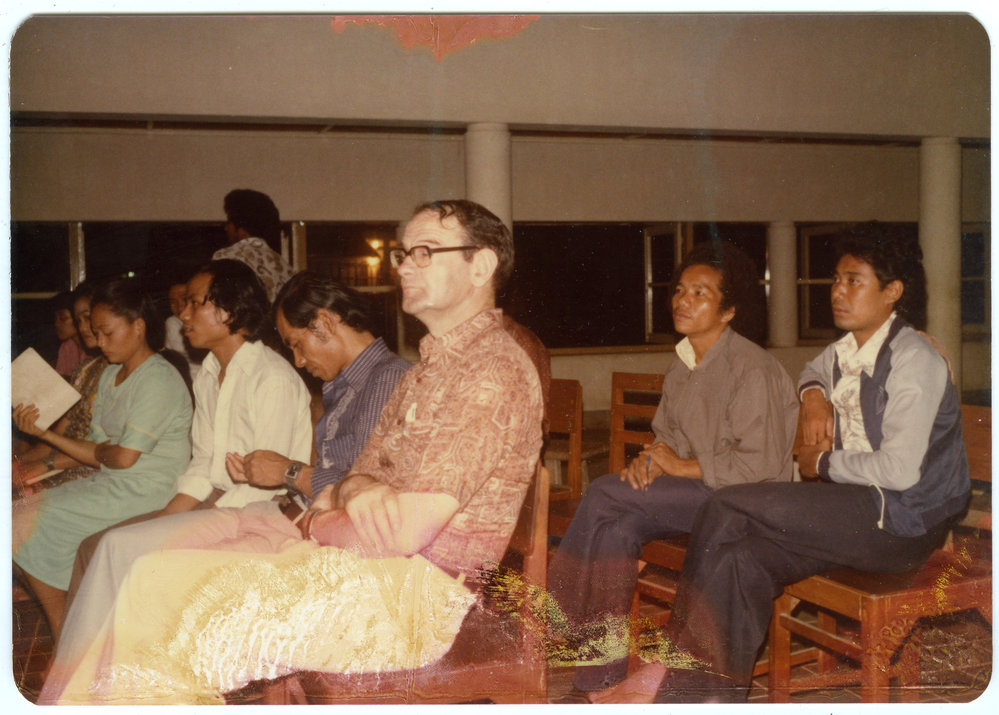 Group of Students and Staff Sitting in a Hall