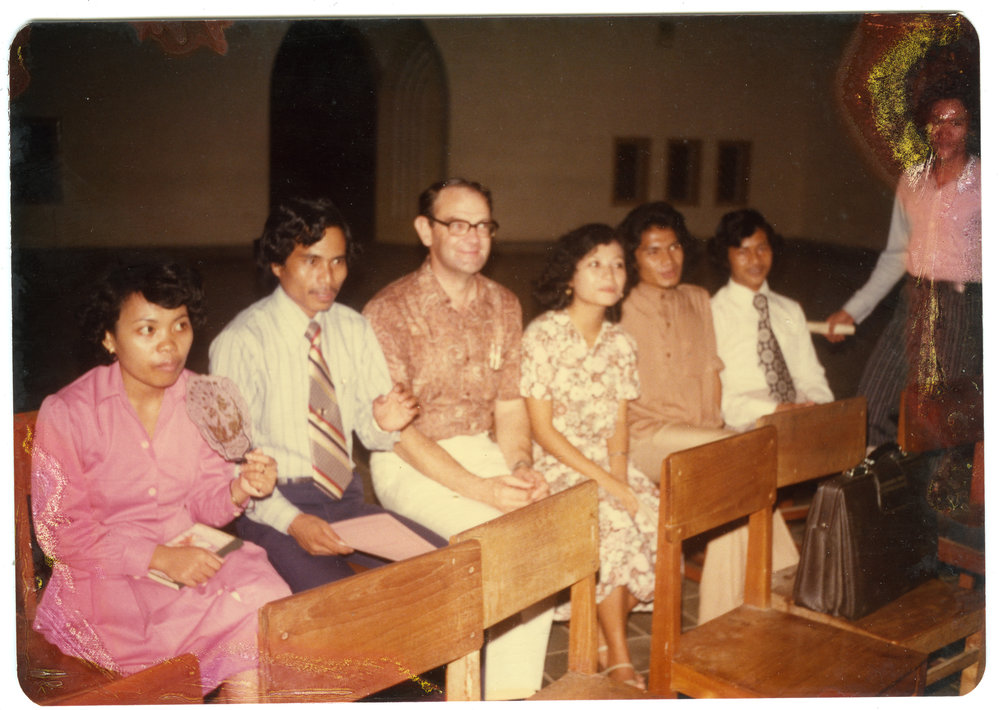 Group of Students and Staff Sitting in a Hall