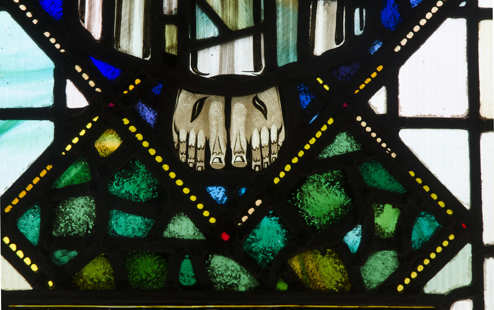 Stained glass image of the feet of Christ