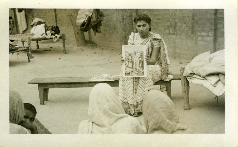 A Biblewoman Talking To A Village Group.
