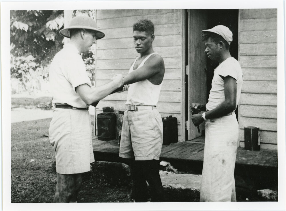 C.K. Crump administers and injection, New Hebrides