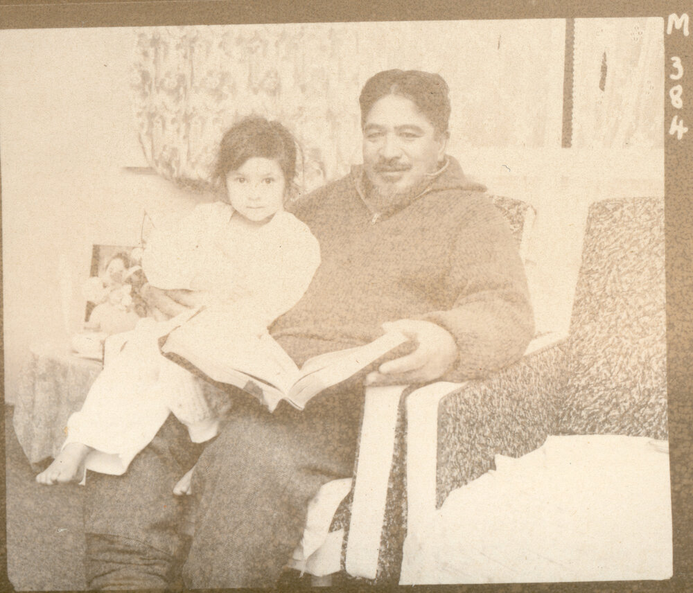 Mr E. Waiariki Reading With His Child (Pat or Honey) 