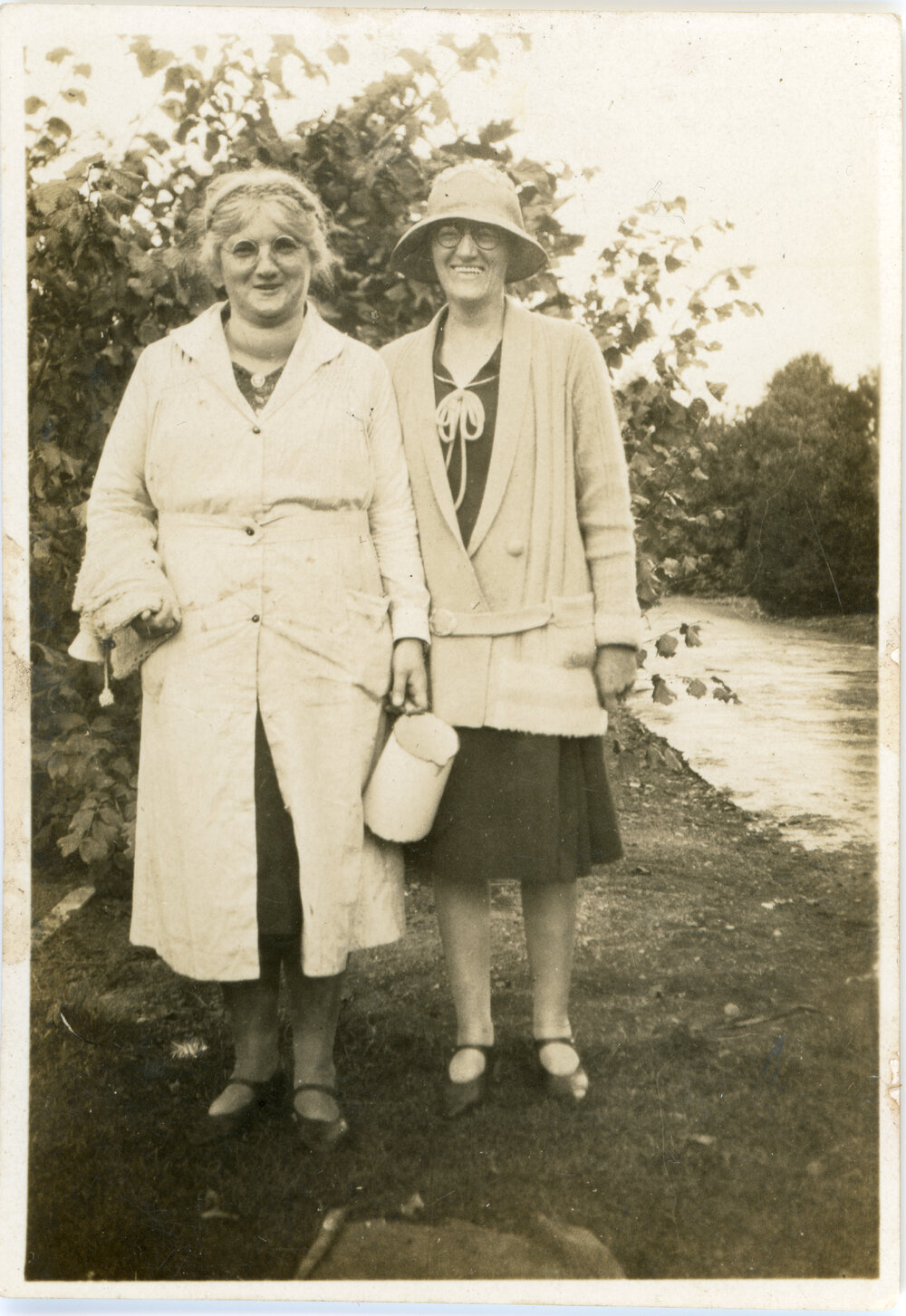 Two Unknown Women Pose Outside