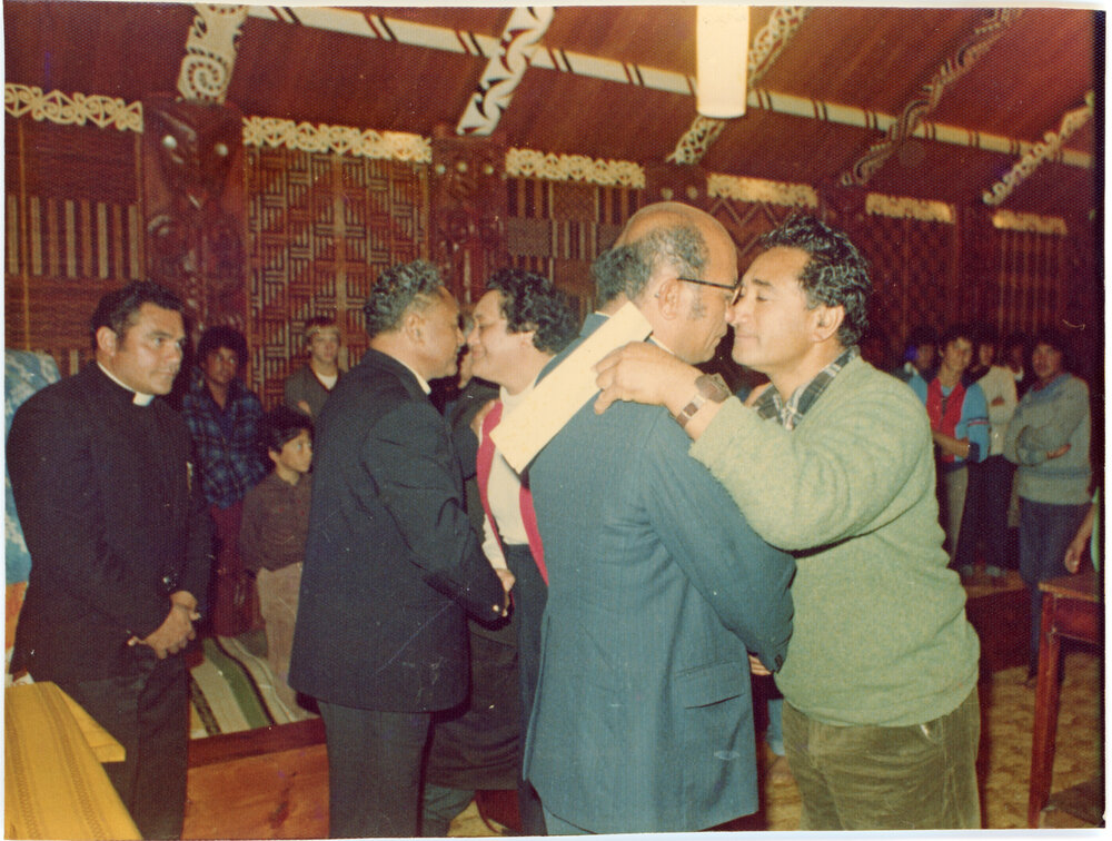 Several At A Church Service Inside a Wharenui Sharing a Hongi