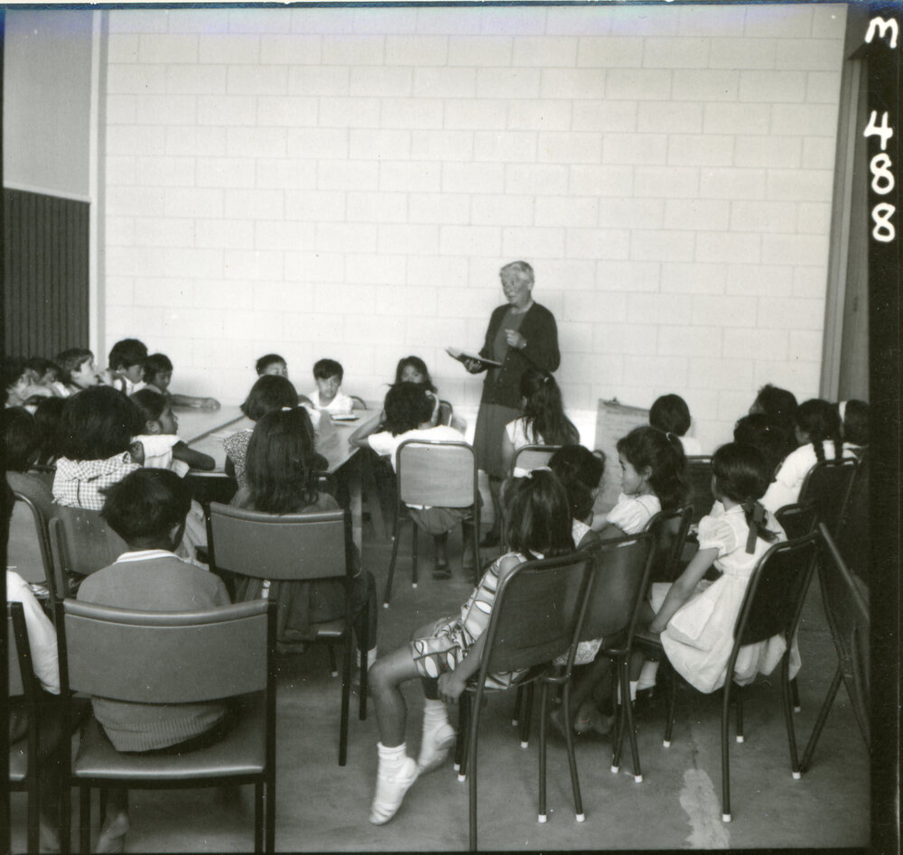 Sr. E. M. Ross Reading to children