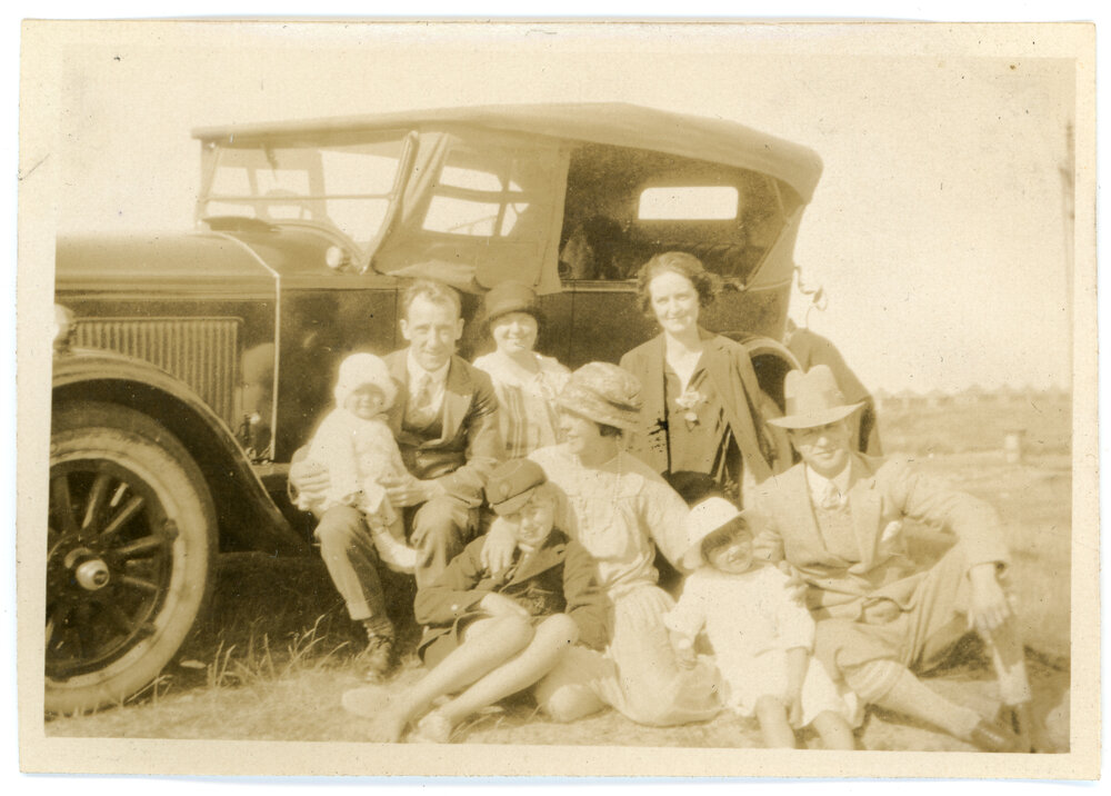 Eight Resting Next To A Car 