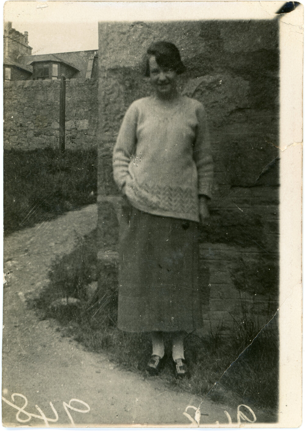Unknown Woman Next To Stone Building