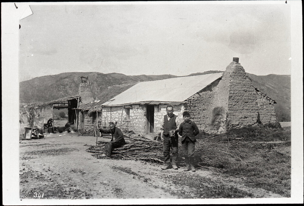 Two Unidentified Chinese Men and Young Boy Near Substantial Sod Home