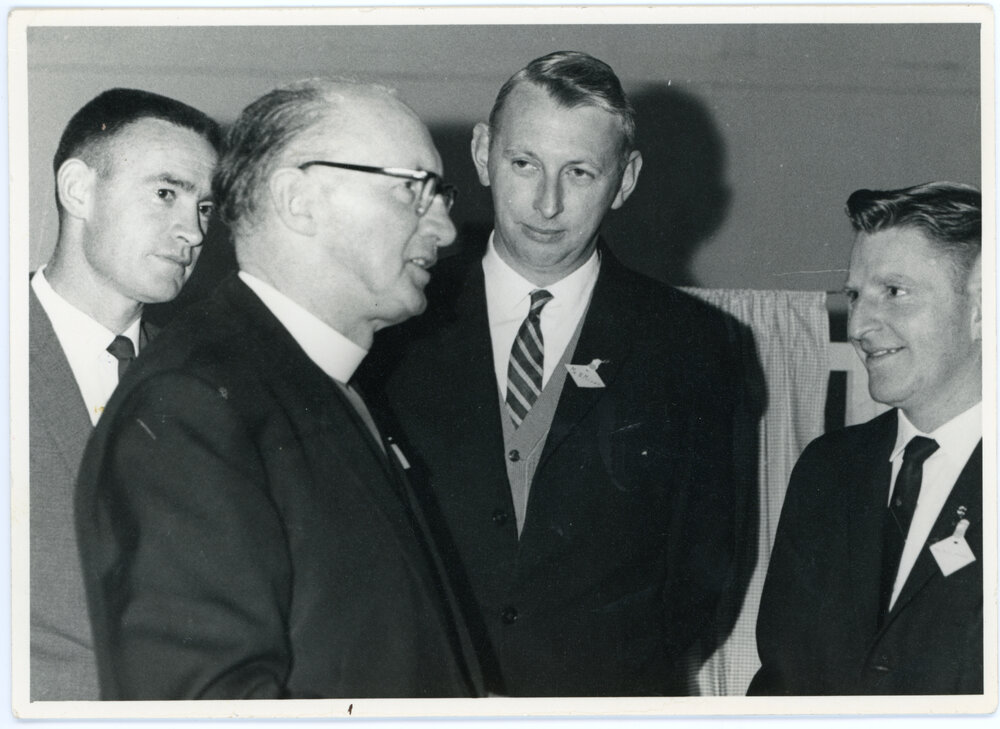 Outgoing Moderator Talking With Three Others