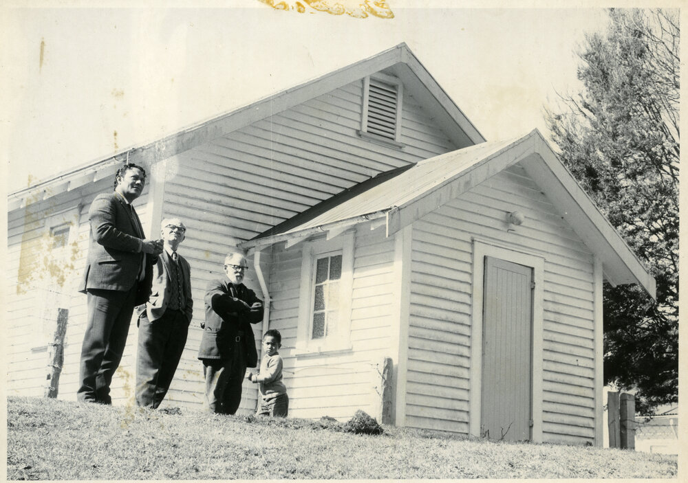 Four people outside the Ruatahuna Church