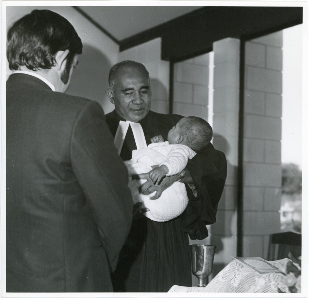 Rev L.I. Sio Baptising a Child
