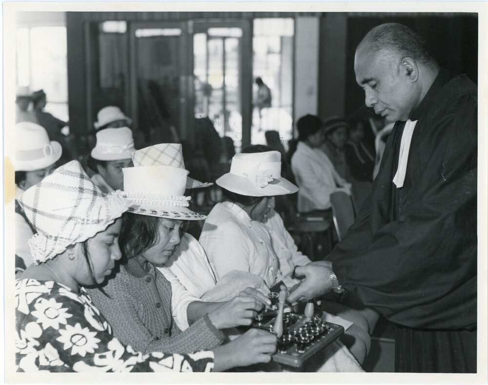 Rev L.I. Sio with Communion During A Service 