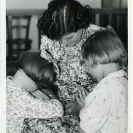 Stephanie Pettit, Miss Halies and Cynthia Mann say their evening prayers, Nesbit Cottage, Glendining Home, 1955