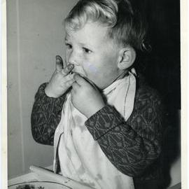 Unknown boy eating at Marama Children's Home, Glendining Home, 1955