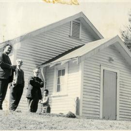Four people outside the Ruatahuna Church