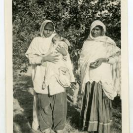 Two unidentified women and a baby