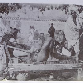 Fakir on a bed of nails