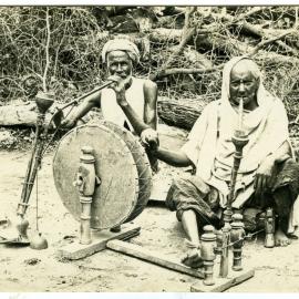Two men spinning cotton