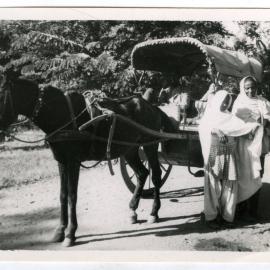 The unidentified women who accompany the town girls to school