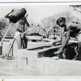 Unidentified men washing in the outdoors