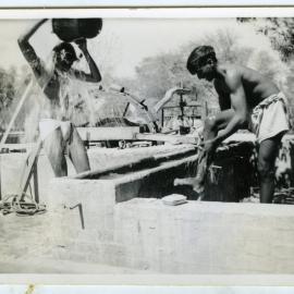 "Morning bath," unidentified men washing in the outdoors