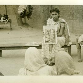 A Biblewoman Talking To A Village Group.