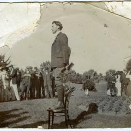 E. J. Tipler preaching or speaking outside [not in uniform], standing on a chair