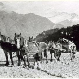 Four horses pull a carriage