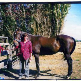 Unidentified woman and a horse