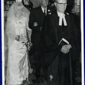 Mary Lauraine Woodcock walking down the aisle with her father, 1966