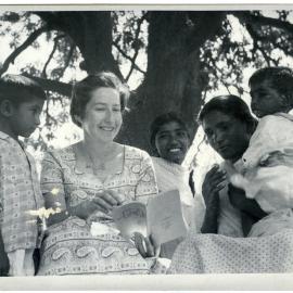 Doreen Riddell reading to Indian mother and children