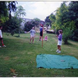 Frances Ede, Gemma Ede and Francis Morton play swingball, John McGovern and Danika McGovern in background, 1992