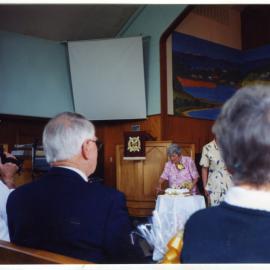 Joan Lodge cutting the cake, St. Enoch's Church