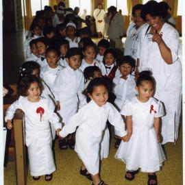 Children and women line up inside Glen Eden Pacific Islanders Church during a White Sunday service, 2002