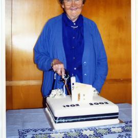 Bernice Mather cuts the 100th Anniversary Cake