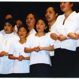 Unidentified group of children and young women singing, General Assembly 2002