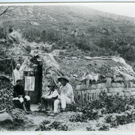 Reverend Alexander Don and three Chinese men seated around a clay brick dwelling